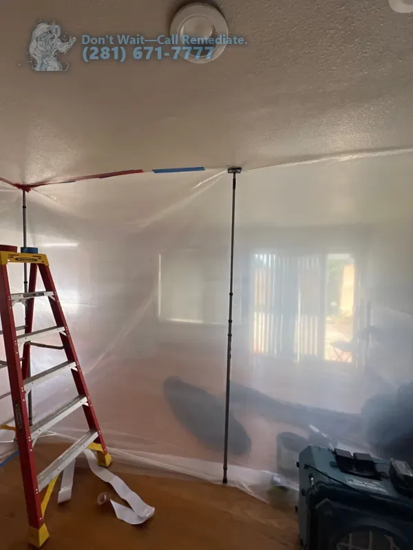 Plastic containment walls and a ladder closing off the work area from the rest of the house