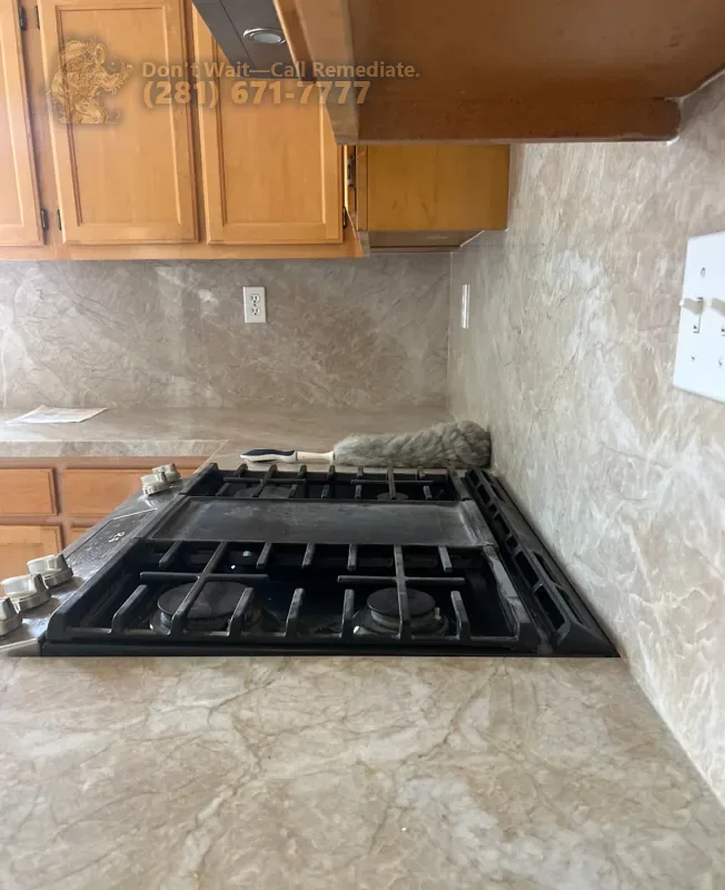 New stone countertop and backsplash around the gas cooktop