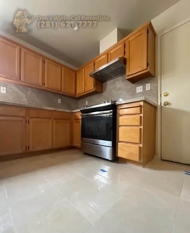 Finished kitchen with cabinets, range and range hood after the work